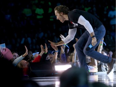 Over 16,000 students and educators gathered for We Day at Canadian Tire Centre in Ottawa Wednesday Nov 9, 2016. Craig Kielburger, co-founder of We, high fives fans at We Day Wednesday.
