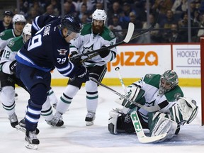 Winnipeg Jets' Patrik Laine (29) scores his second goal of the night against Dallas Stars goaltender Kari Lehtonen (32) as Jordie Benn (24) and Radek Faksa (12) defend during second period NHL action in Winnipeg on Tuesday, November 8, 2016.