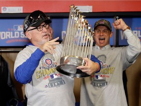 Manager Joe Maddon of the Chicago Cubs reacts with The Commissioner's Trophy after the Chicago Cubs defeated the Cleveland Indians 8-7 in Game Seven of the 2016 World Series at Progressive Field on November 2, 2016 in Cleveland, Ohio. The Cubs win their first World Series in 108 years.