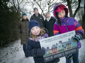 A group of residents gathered in Stanley Park area to express how upset about the city's plan to use much of the park as construction zone Sunday December 11, 2016. For a couple of years, it will be the major staging area for this Overflow Sewage System that is being built in a six-kilometre stretch across Ottawa. L-R Front row: Three and a half year old Sophie Slinn and seven year old Yasmin Dhanani hold the sign in front of L-R Lillian Lai, David Slinn and Victoria Henry.