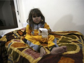 A Syrian child, evacuated from Aleppo, sits in a field hospital bed near Idlib, Syria, Friday, Dec. 16, 2016.  Turkey's Foreign Minister Mevlut Cavusoglu says 7,500 civilians have been evacuated from the Syrian city of Aleppo and that he is trying to help keep the process on track.(AP Photo) ORG XMIT: ANK110