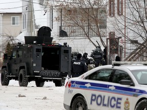 A tactical team moves into a house at 223 Desrosiers St. in Vanier, believing an armed assailant was barricaded inside. There was no one home.