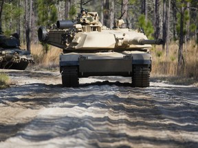 U.S. Marines with 2d Tank Battalion, 2d Marine Division (2D MARDIV), and 3rd Battalion, 6th Marine Regiment, 2D MARDIV, conduct urban operations with M1A1 Abrams tanks during the Iron Blitz field exercise on Camp Lejeune, N.C., Feb. 21, 2016. The exercise was conducted to increase the Marines proficiency in both offensive and defensive operations on unfamiliar terrain. (U.S. Marine Corps photo by Lance Cpl. Abraham Lopez, 2D MARDIV Combat Camera/Released)