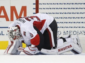 Ottawa Senators goalie Andrew Hammond (30) kneels on the ice after he was hurt during a scrum in the first period of an NHL game against the Islanders on Dec. 18, 2016, in New York.