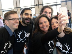 Angela Lariviere from Halogen Software takes a quick selfie with colleagues, from left, Tom Cruickshank, David Aslani, David Beaton and Rachel Paquette while volunteering at the Hamper Packing Day, held at the Horticulture Building at Lansdowne Park on Wednesday, December 21, 2016, in support of the Christmas Exchange Program run by the Caring and Sharing Exchange.