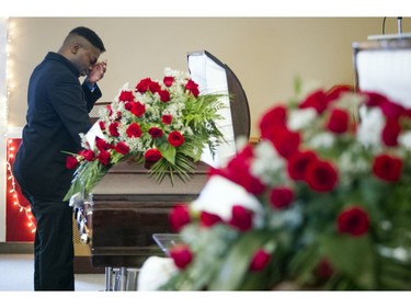 David Muzaliwa, the girls brother, wipes his eyes at Elizabeth's casket.