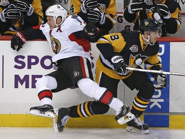 The Ottawa Senators' Chris Neil collides with the Pittsburgh Penguins' Brian Dumoulin in the first period.