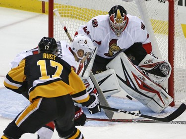 The Pittsburgh Penguins' Bryan Rust gets the puck between the pads of Ottawa Senators goalie Craig Anderson for a goal.