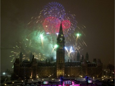Fireworks explode over Parliament Hill.