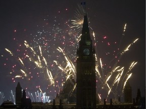 Fireworks explode over Parliament Hill.