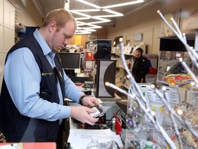 Canada Revenue Agency raid at the Glebe Smokeshop in Ottawa, December 07, 2016. Agent seems to be replicating the Point of Sale hard drive.