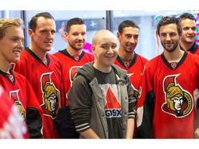 Cancer patient Tanner Stevenson, 15, is just one of the boys as the Ottawa Senators make their annual Christmas visit to CHEO and visit with some of the children and staff. They also brought gifts including a DSLR camera, video games, movies, blankets and plush Sparty dolls for CHEO's use in its effort to enhance the lives of hospital patients.