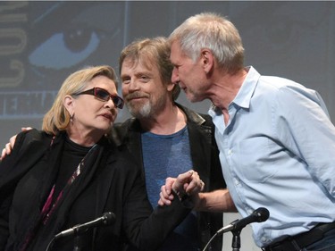 In this July 10, 2015 file photo, Carrie Fisher, from left, Mark Hamill, and Harrison Ford attend Lucasfilm's "Star Wars: The Force Awakens" panel on day 2 of Comic-Con International in San Diego, Calif. Ford stars as Hans Solo in the new film, "Star Wars: The Force Awakens," releasing in U.S. theaters on Dec. 18, 2015.