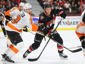 Chris Neil battles with Roman Lyubimov in the first period as the Ottawa Senators take on the Philadelphia Flyers in NHL action at Canadian Tire Centre. Chris Neil has played 995 NHL games.
