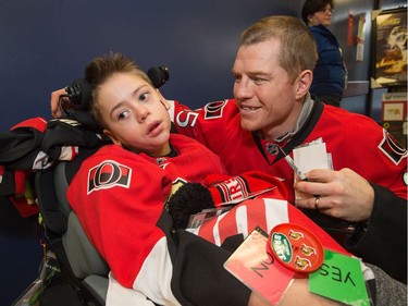 Chris Neil visits with Matthew Parvan, 10, as the Ottawa Senators make their annual Christmas visit to CHEO and visit with some of the children and staff. They also brought gifts including a DSLR camera, video games, movies, blankets and plush Sparty dolls for CHEO's use in its effort to enhance the lives of hospital patients.