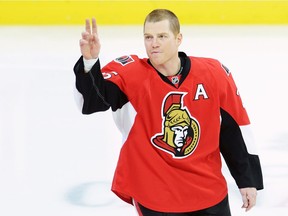 Ottawa Senators' Chris Neil salutes the crowd during a ceremony to mark his 1,000th NHL game prior to NHL action against the San Jose Sharks on Wednesday, December 14, 2016 in Ottawa.