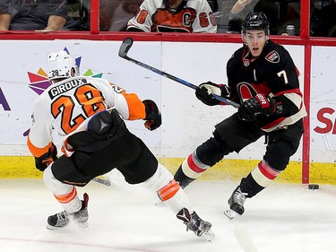 Claude Giroux and Kyle Turris battle for the puck in the second period as the Ottawa Senators take on the Philadelphia Flyers in NHL action at Canadian Tire Centre.