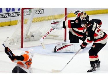 Flyers centre Claude Giroux fires a puck past Sens goalie Mike Condon.