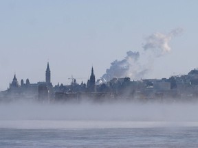 Parliament buildings and city downtown across the Ottawa River--extreme cold winter weather.