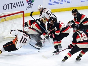 Anaheim Ducks' Corey Perry, left, misses on an attempt to put the puck past Ottawa Senators' Mike Condon during second period NHL hockey action in Ottawa on Thursday, Dec. 22, 2016.