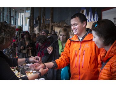 Jimmy Bernard along with Marie-Claude Pellerin finds a bracelet at Manon Tremblay's Stone Era display.