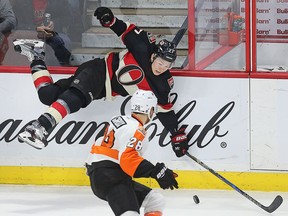 Curtis Lazar is upended with Claude Giroux looking on in the second period as the Ottawa Senators take on the Philadelphia Flyers in NHL action at Canadian Tire Centre.