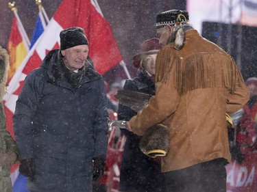 Gov. Gen. David Johnston participates in a smudging ceremony with Algonquin Elder Albert Dumont during a New Year's Eve celebration on Parliament Hill.