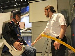 At the Cosmodome in Laval, Simon Beaudoin, right, instructs writer Peter Johansen on the operation of a Manned Maneuvering Unit, one of six simulators visitors can access.  Normally, the simulators are used exclusively for multi-day camps offered throughout the year.