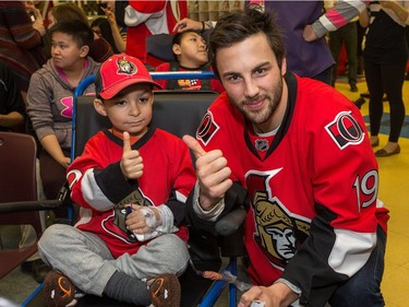 Derick Brassard and Xavier Najm, 4, share a thumbs up as the Ottawa Senators make their annual Christmas visit to CHEO and visit with some of the children and staff. They also brought gifts including a DSLR camera, video games, movies, blankets and plush Sparty dolls for CHEO's use in its effort to enhance the lives of hospital patients.