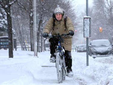 Despite 16 centimetres of snow and slick roads, cyclist Alan Pattison was still determined to get out on his bike for some exercise along Laurier Avenue in Sandy Hill Monday morning (Dec. 12, 2016).