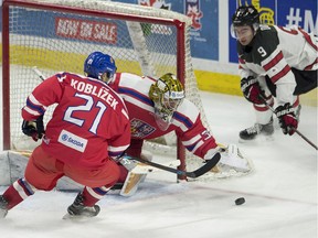 Team Czech Republic goalie Daniel Vladar dives for a loose puck as Radek Koblizek, left, and Team Canada's Dillon Dube look on during second period World Junior pre-tournament hockey action Wednesday December 21, 2016 in Ottawa.