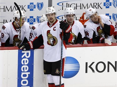 Ottawa Senators' Erik Karlsson stands in front of his bench as the hats are cleared off the ice after a hat trick by Pittsburgh Penguins' Bryan Rust in the third period of an NHL hockey game in Pittsburgh, Monday, Dec. 5, 2016. The Penguins won 8-5.