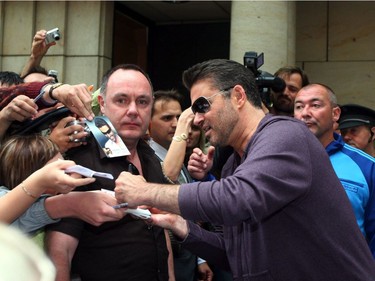 George Michael leaves the Four Seasons hotel on his way to the airport where a private jet was waiting to fly him back to London. George was supposed to perform in the Cezch capital but the concert got cancelled because a truck with some of his equipment crashed on the way to the venue.