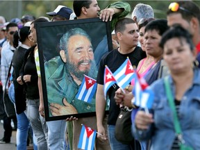 People line the side of a road while waiting for the caravan transporting the remains of former Cuban President Fidel Castro pass by on its four-day journey across the country Dec. 2, 2016 in Camaguey, Cuba.