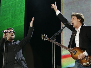 In this July 2, 2005, file photo, George Michael, left, and Paul McCartney, right, perform during the Live 8 concert in Hyde Park, London. The concert is part of a series of free concerts being held around the world designed to press leaders of the rich G8 countries to help impoverished African nations. Michael, who rocketed to stardom with WHAM! and went on to enjoy a long and celebrated solo career lined with controversies, has died, his publicist said Sunday, Dec. 25, 2016. He was 53.