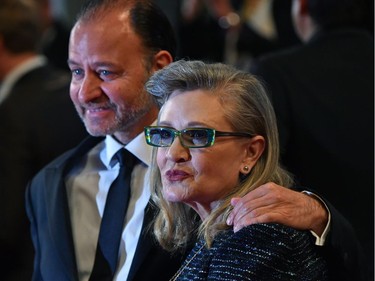 This file photo taken on May 14, 2016 shows US actress Carrie Fisher poses with US actor and director Fisher Stevens for the screening of the film "Agassi (The Handmaiden - Mademoiselle)" at the 69th Cannes Film Festival in Cannes.