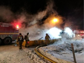 Firefighters are surrounded by vapour as they battle a fire on Hedley Way in Kanata Friday, Dec, 17 Scott Stilborn photo.