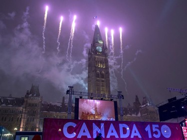 Fireworks light up the sky behind the Peace Tower.