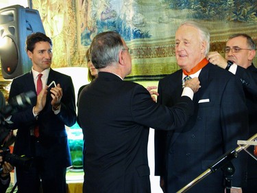 Former prime minister Brian Mulroney was presented by French Ambassador Nicolas Chapuis the insignia of Commander of the National Order of the Legion of Honour at the Embassy of France on Tuesday, December 6, 2016 while guests, including prime minister Justin Trudeau, applaud.