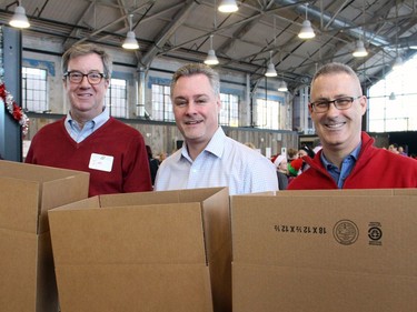 From left, Mayor Jim Watson and city councillors Mark Taylor (Bay Ward) and Keith Egli (Knoxdale-Merivale Ward) were among the community leaders to volunteer at the Hamper Packing Day, held at the Horticulture Building on Wednesday, December 21, 2016, in order to fill 500 food hampers for individuals and families in need this Christmas.