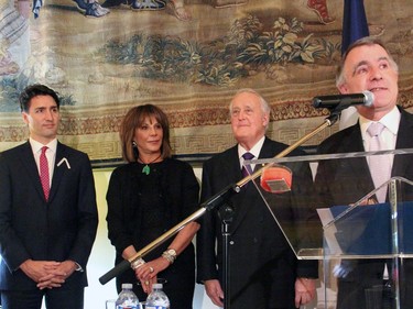 From left, Prime Minister Justin Trudeau, Mila Mulroney and former prime minister Brian Mulroney listen as French Ambassador Nicolas Chapuis speaks at the Embassy of France on Tuesday, December 6, 2016, prior to the induction of Mulroney into the French Legion of Honour.