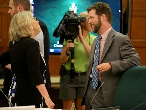 Conservative MP Scott Reid, right, chats with Green party leader Elizabeth May during one meeting of the electoral reform committee last summer.