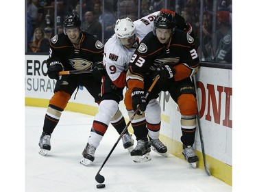 Anaheim Ducks left wing Jakob Silfverberg (33), of Sweden, controls the puck with Ottawa Senators right wing Bobby Ryan (9) on his back and Anaheim Ducks defenseman Shea Theodore (53) trailing during the first period of an NHL hockey game in Anaheim, Calif., Sunday, Dec. 11, 2016.