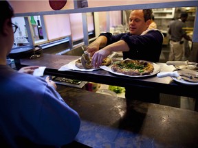 James Alefantis, the owner of the pizza place Comet Ping Pong, slices pizza at the restaurant in Washington, Nov. 19, 2016.