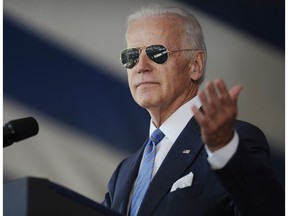In this May 2015 photo, Vice President Joe Biden gestures after donning a pair of sunglasses as he delivers the Class Day Address at Yale University in New Haven, Conn.