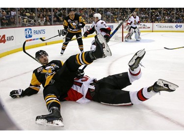 The Pittsburgh Penguins' Justin Schultz falls on top of the Ottawa Senators' Zack Smith in the second period.
