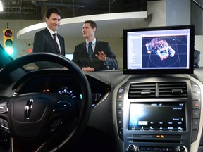 Blackberry QNX Director of Engineering Sheridan Ethier speaks to Prime Minister Justin Trudeau as he visits the Blackberry QNX facility in Ottawa on Monday, Dec 19, 2016.