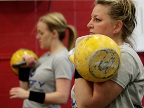 (left to right) Michaela Vermeulen and Rhonda Browning take part in a kettlebell sport competition at The Foundry, 4904 - 87 Street, in Edmonton Alta., on Saturday June 14, 2014.