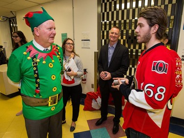 Kevin Keohane, (L) President of CHEO Foundation, chats with Mike Hoffman as the Ottawa Senators make their annual Christmas visit to CHEO and visit with some of the children and staff. They also brought gifts including a DSLR camera, video games, movies, blankets and plush Sparty dolls for CHEO's use in its effort to enhance the lives of hospital patients.