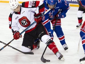 The Kitchener Rangers' Riley Damiani battles the Ottawa 67's Drake Rymsha for the puck at TD Place arena on Saturday, Dec. 3, 2016.